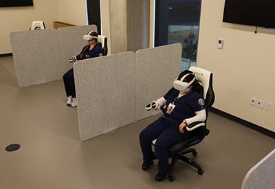 2 nursing students testing virtual simulation machines in VR Lab