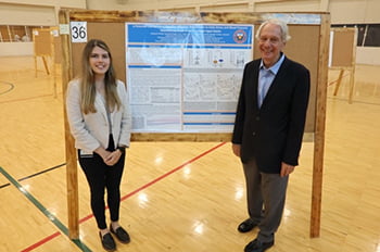 Ashley Darling standing with poster presentation