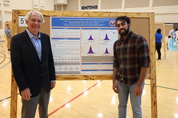 Jeremiah_Joseph standing with poster presentation