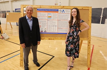 Kendal_Keeton standing with poster presentation