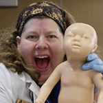 Crystal Roden smiling with baby sim mannequin