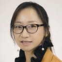 Portrait of Xiangli Gu with a grey background