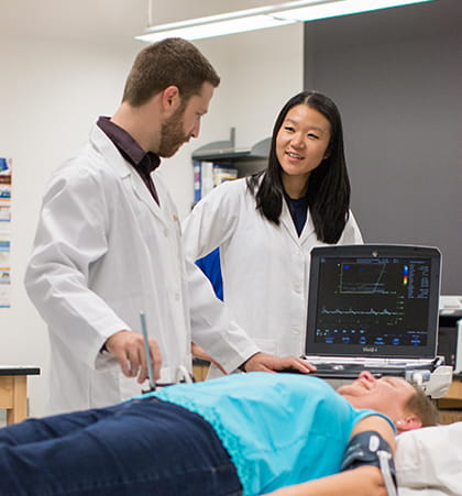 Dr. Ryan Rosenberry and Susie Chung study a patient in the Applied Physiology and Advanced Imaging Laboratory.