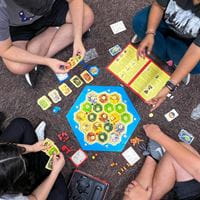 Overhead view of students playing the game "Catan."