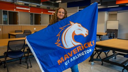 Brianna Devito holding the UTA school flag