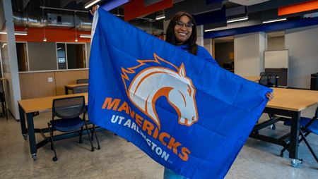 Raven Parker holding the UTA school flag