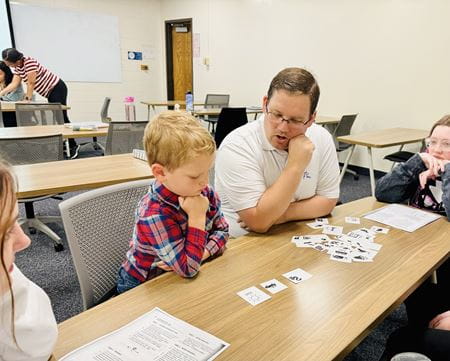 Photo of the instructor, Dr. John Romig, working with 3-year-old Will. 