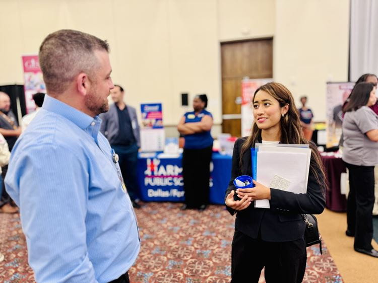 Photo of senior Valery Lezama talking to a recruiter at the career day event 