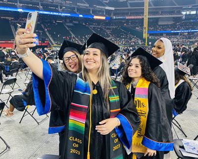 UTA College of Education students pose for a group selfie at the Spring 2023 Commencement at Globe Life Park
