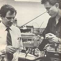 Dr. Bob Woods and a mechanical engineering student inspect a Formula SAE engine