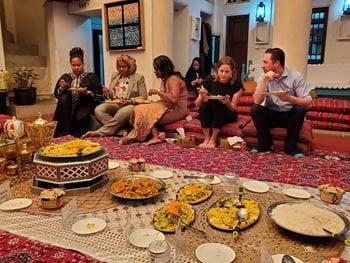 UTA Executive MBA students eating cuisine in mosque during UAE visit