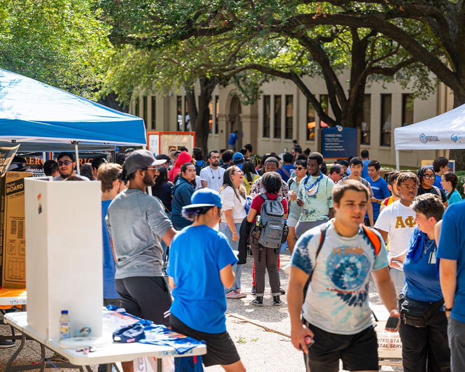 students walking outside at the student organization fair
