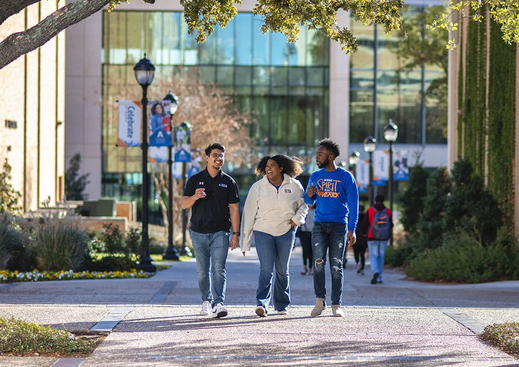 three students walking together on campus