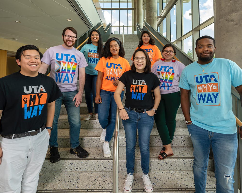 group of students posing on the stairs in the seir building at uta