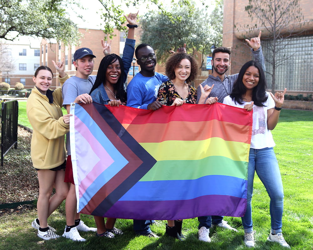 students holding pride flag
