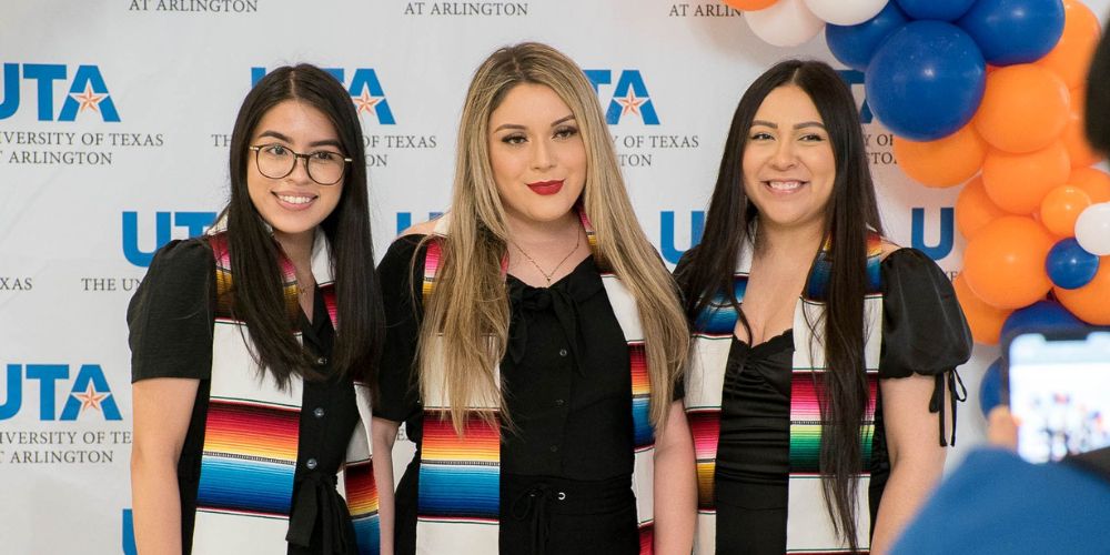 three hispanic women with mexican themed scarfs on