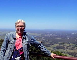 photograph of dr. beth haller standing in front of a scenic background in australia