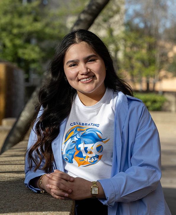female student wearing the university's 130th anniversary t-shirt