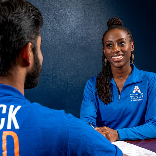 a woman speaking to a man