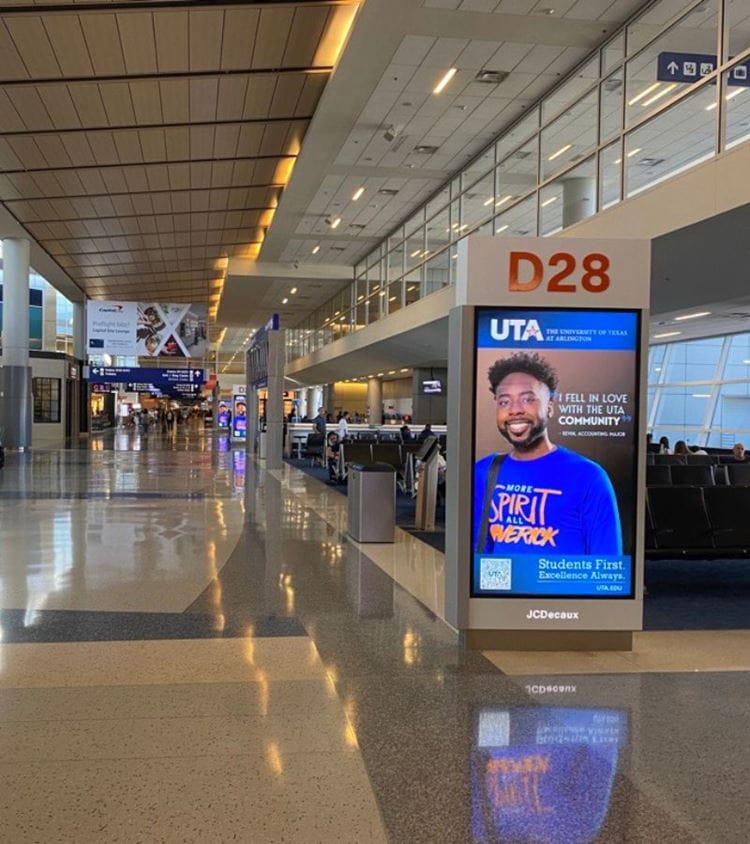 UTA student in an airport ad at dfw gates