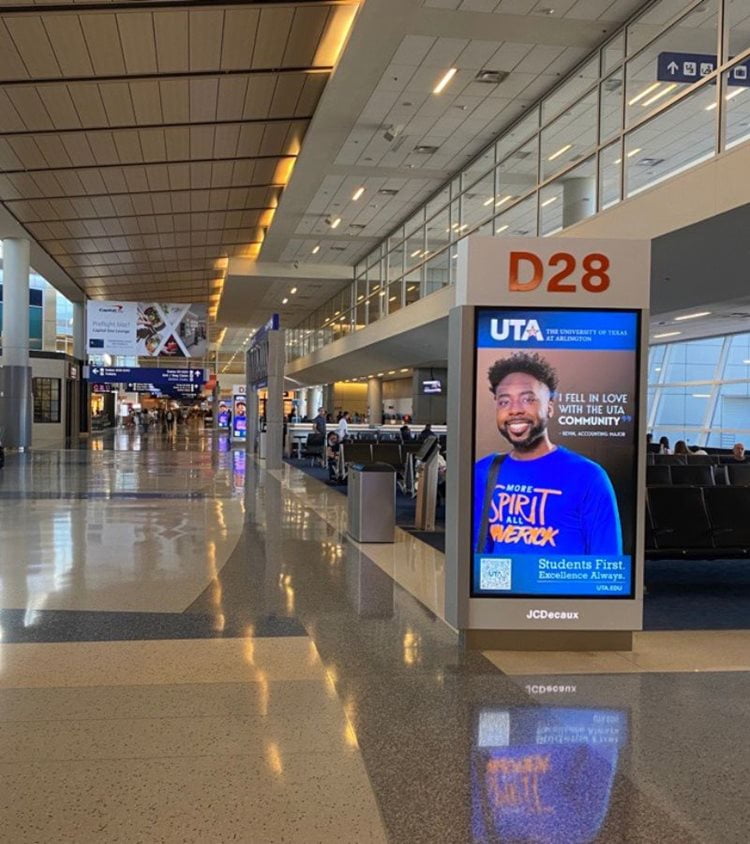 UTA student in an airport ad at dfw gates