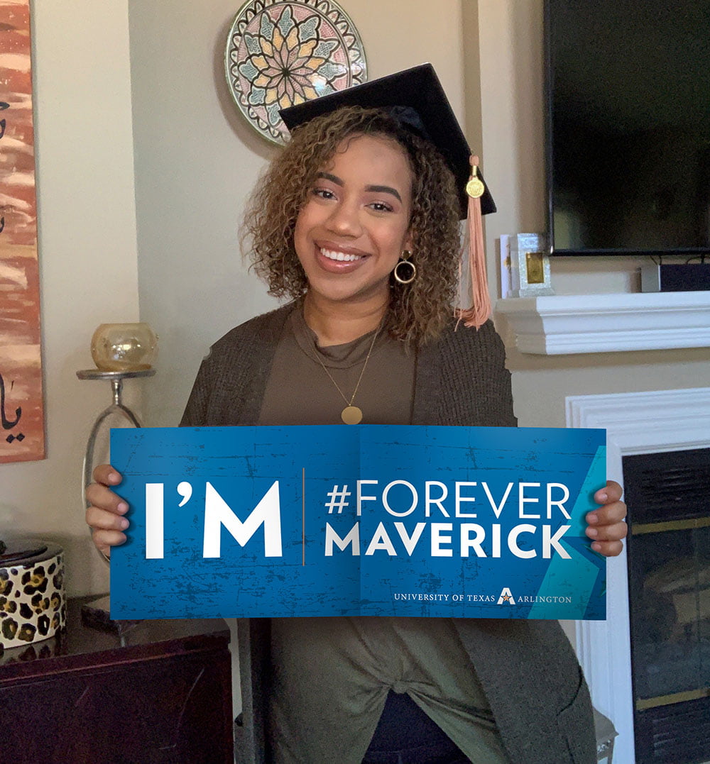 student holding forever maverick poster