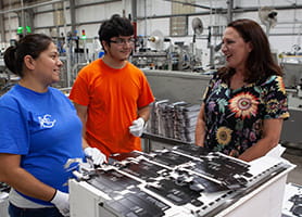 photo of Jana Harris with employees at Harris Packaging