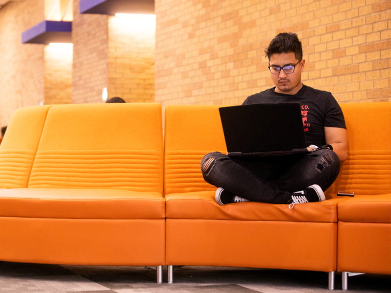UTA student sitting alone in University Center" _languageinserted="true
