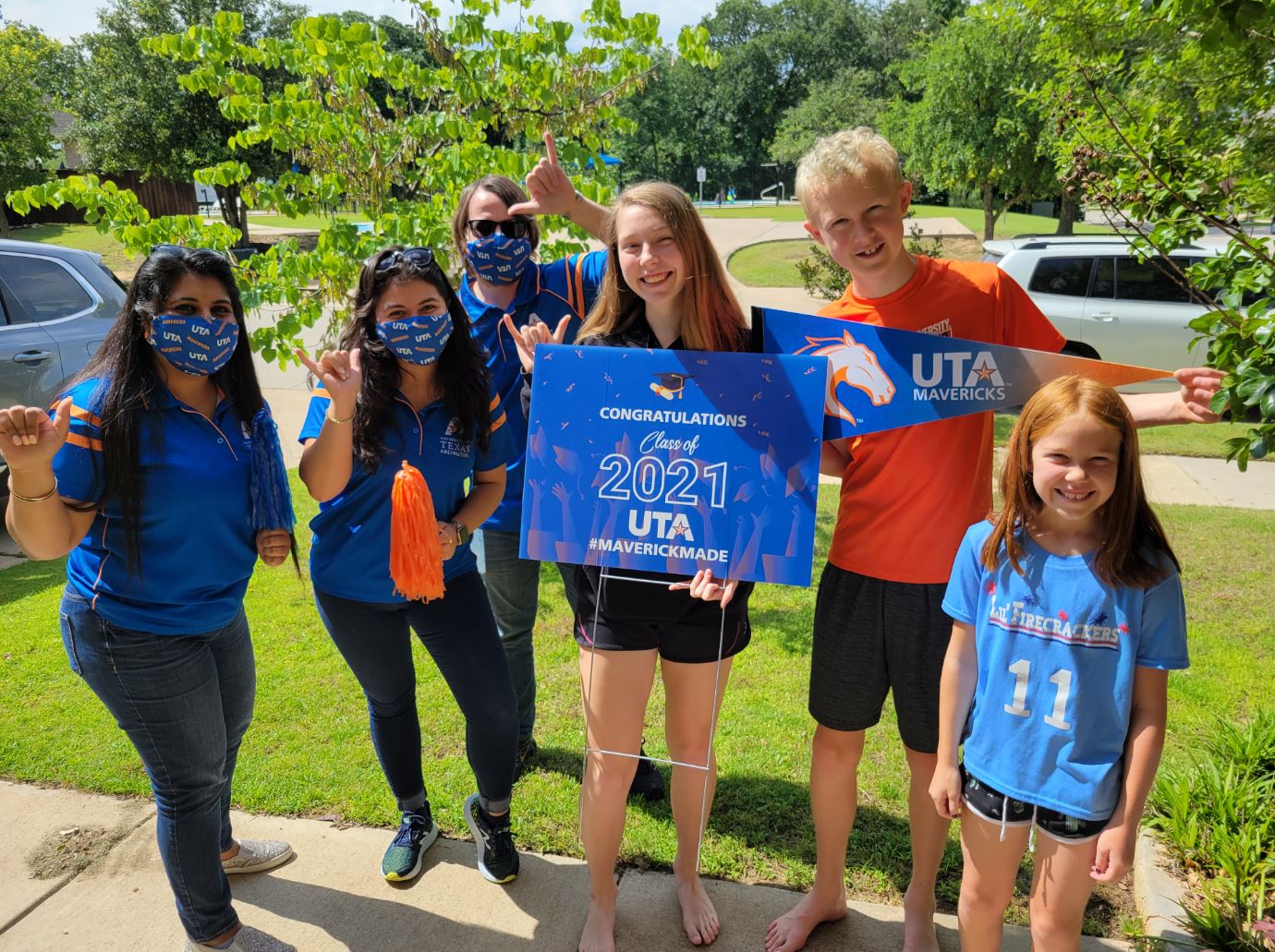 Bailey Samide, holding a UTA sign, with UTA staff and members of her family" _languageinserted="true