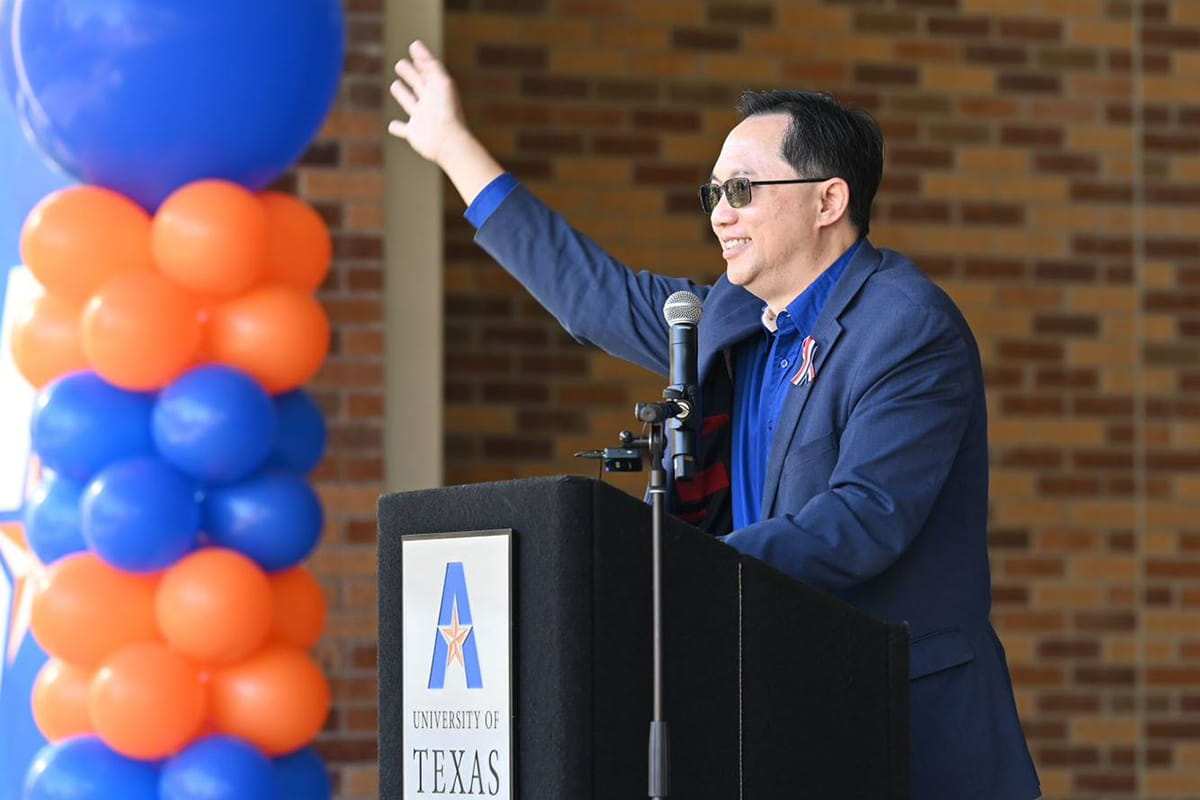 Attendees celebrate the Texas Tier One achievement at a UTA event." _languageinserted="true