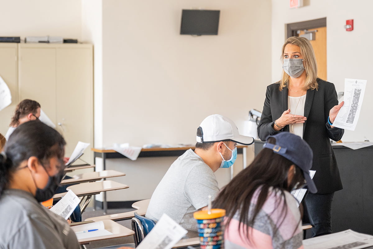 Erin Carlson, associate professor of public health, lectures in a UTA classroom.