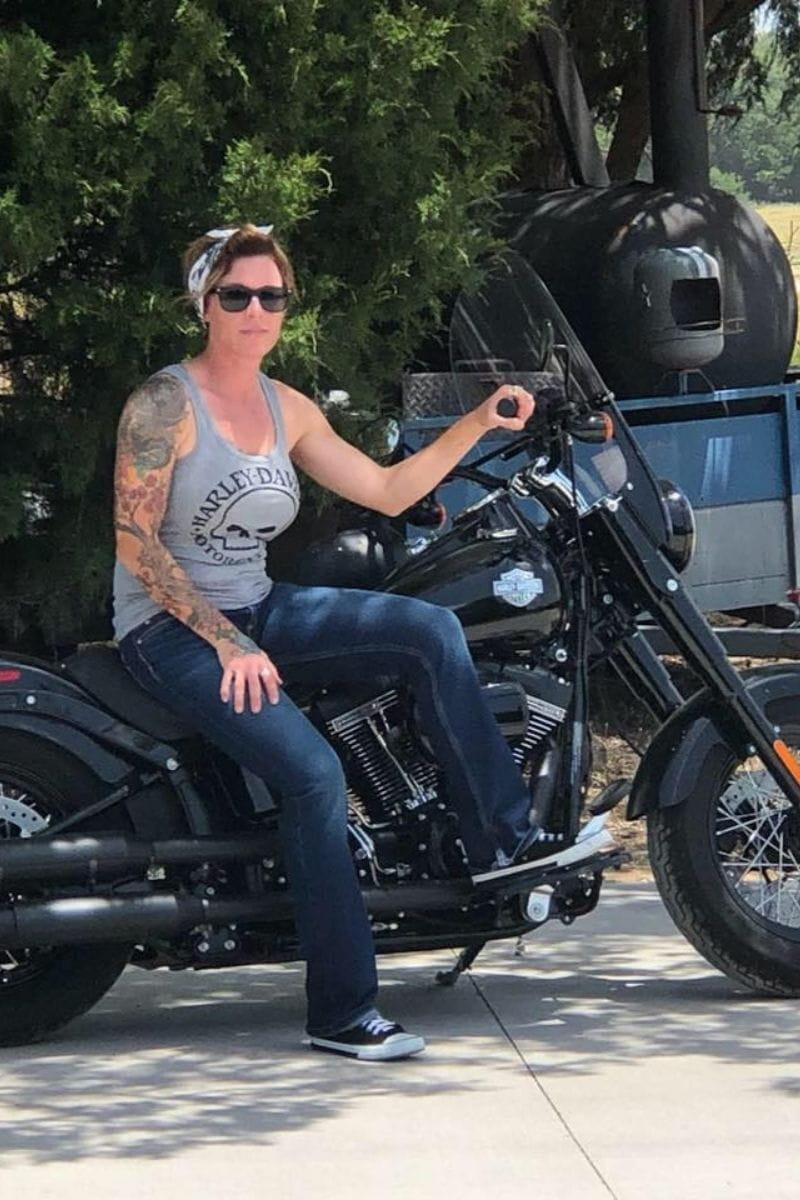 Jodie Wofford poses for photo while sitting on her motorcycle." _languageinserted="true