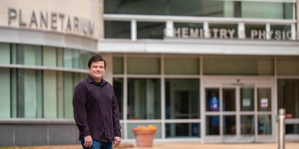 Rick Wilder poses for photo in front of UTA Planetarium" _languageinserted="true