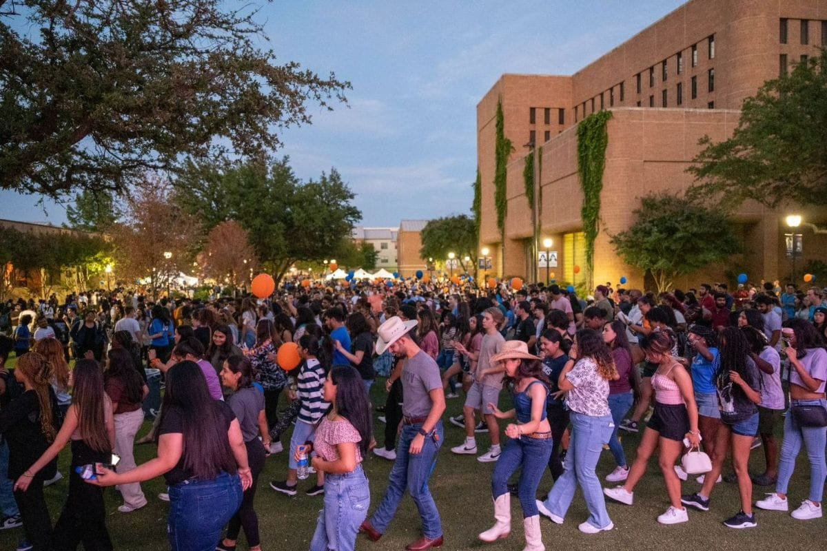 Students line dance at Brazos Park during 2022 Waffleopolis event