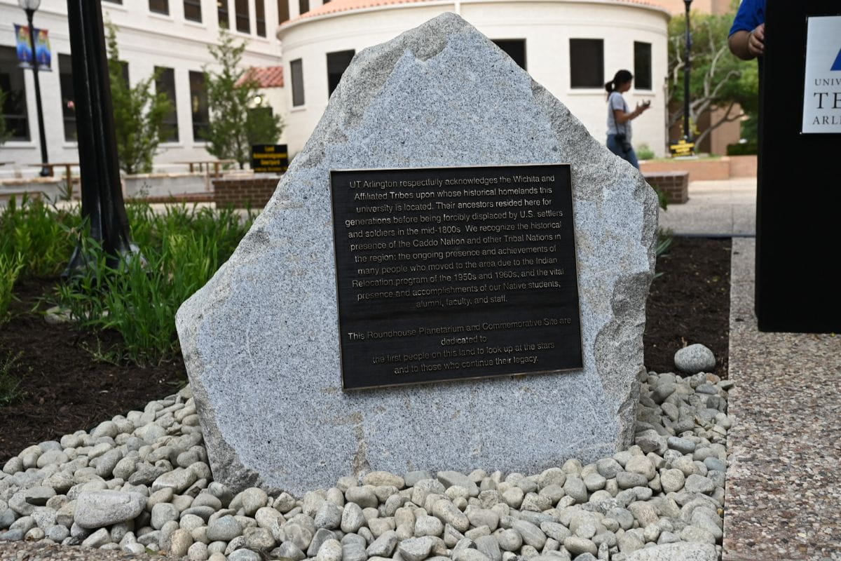 A boulder marks the entrance to the Native American courtyard at UTA.