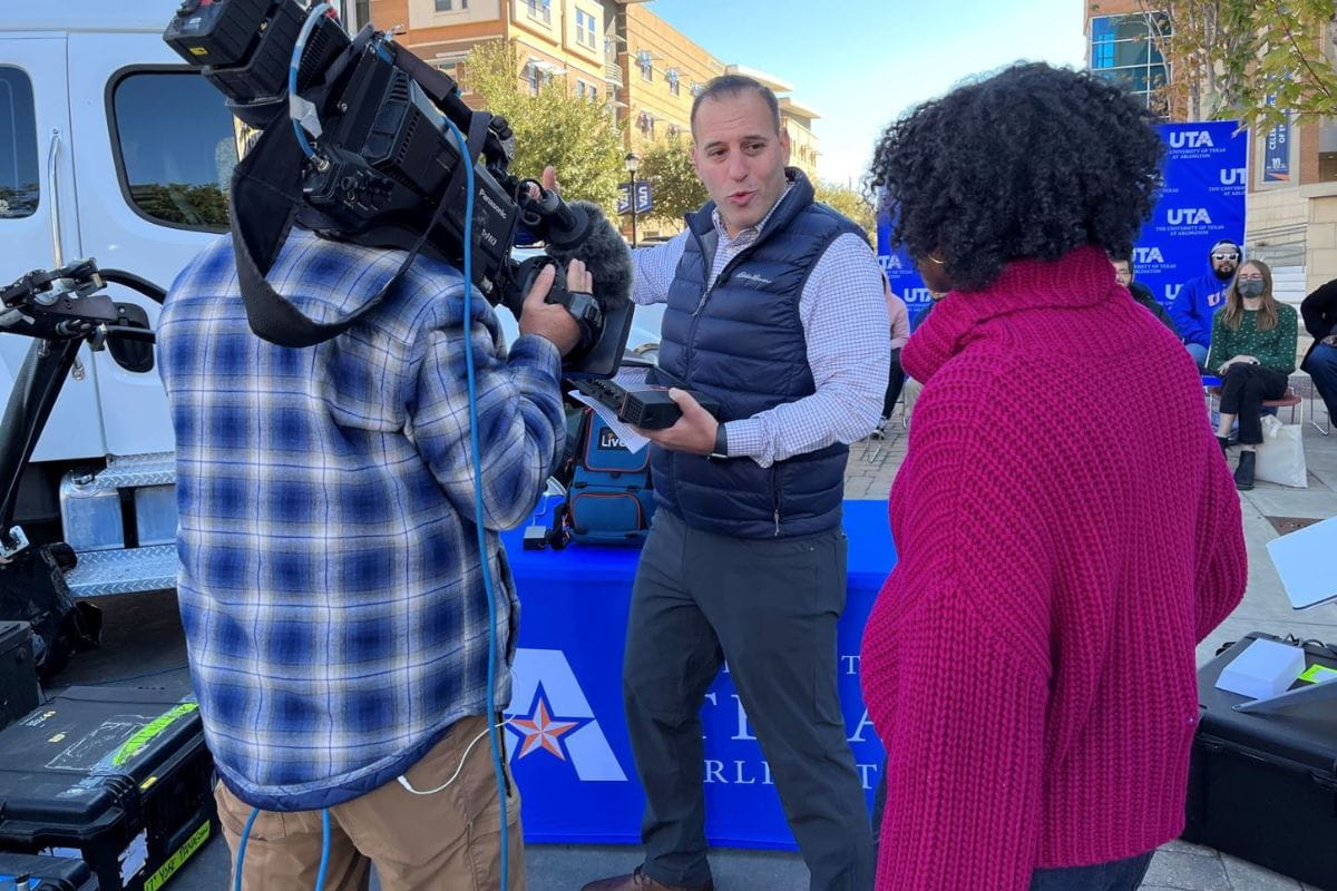 Photo of Mark Weinstock, NBC vice president of news field operations and engineering, on campus demonstrating technology at UTA." _languageinserted="true