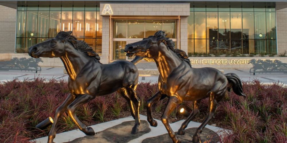 Photo features statue of galloping horses located outside of UTA