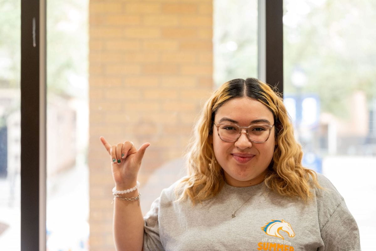 UTA student Sharon Romero poses with "Mavs Up" hand gesture" _languageinserted="true
