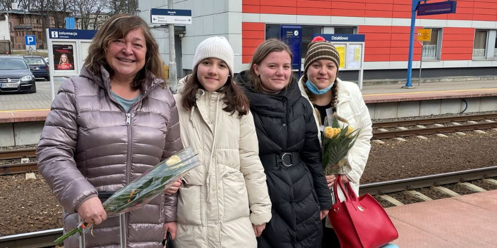 Olexandra Shevchenko pictured with her mother and cousins at a train station in Poland." _languageinserted="true