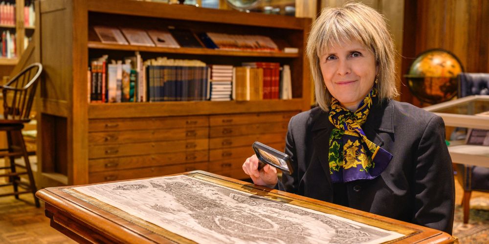 Mary Vaccaro holding magnifying glass 