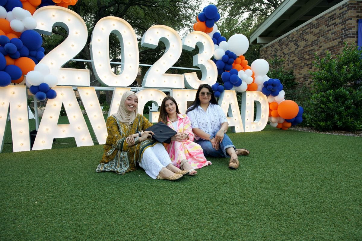 Group of three poses in front of sign that reads 2023 Mavgrad" _languageinserted="true