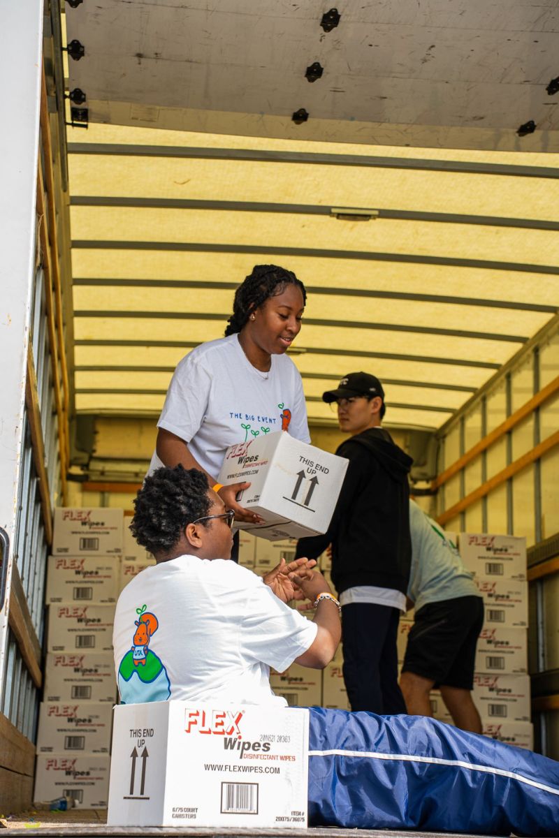 The Big Event volunteers moving boxes 