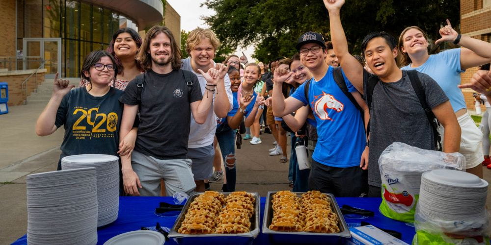 A group of students line up for Waffleopolis