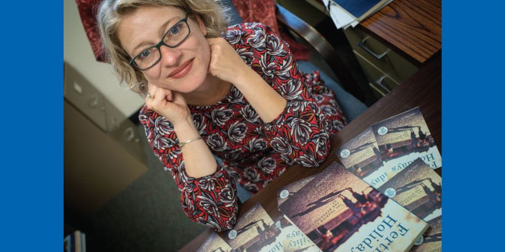 Amy Speier, UTA associate professor of anthropology, poses with books" _languageinserted="true