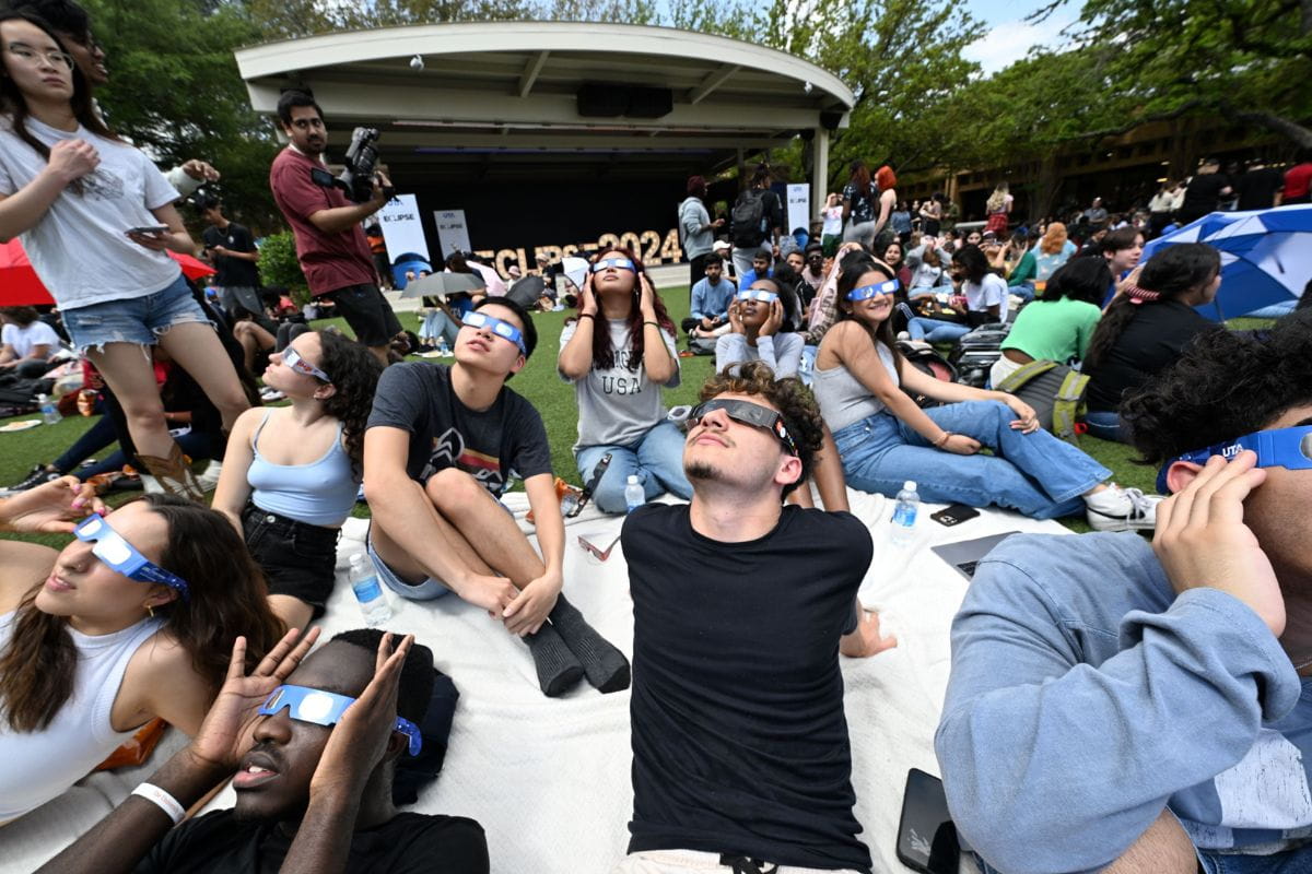 Members of UTA community look up at solar eclipse at Brazos Park