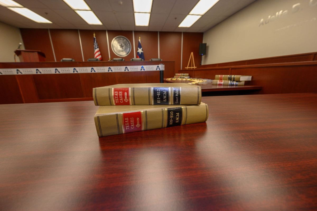 Stacked books in mock trial room" _languageinserted="true