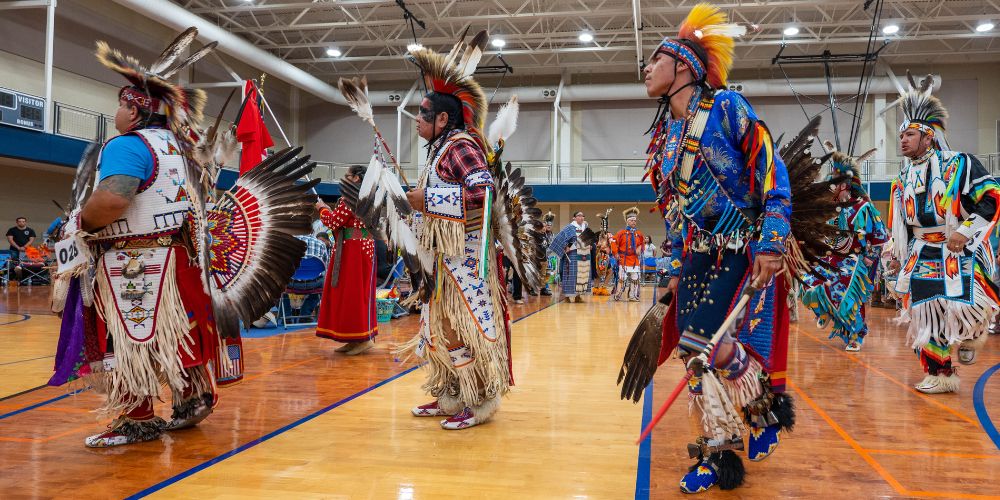 Four men dancing in Native American Student Association powwow