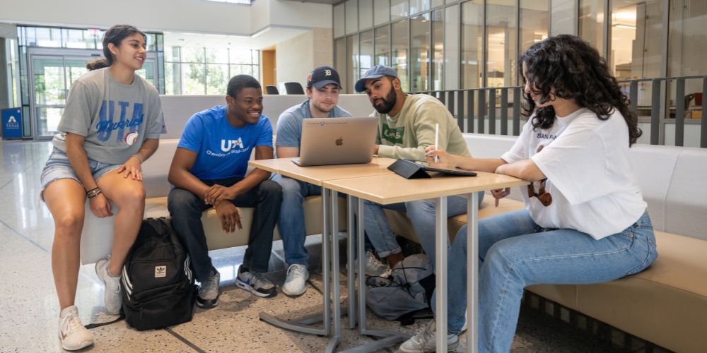 Students gathered around a computer