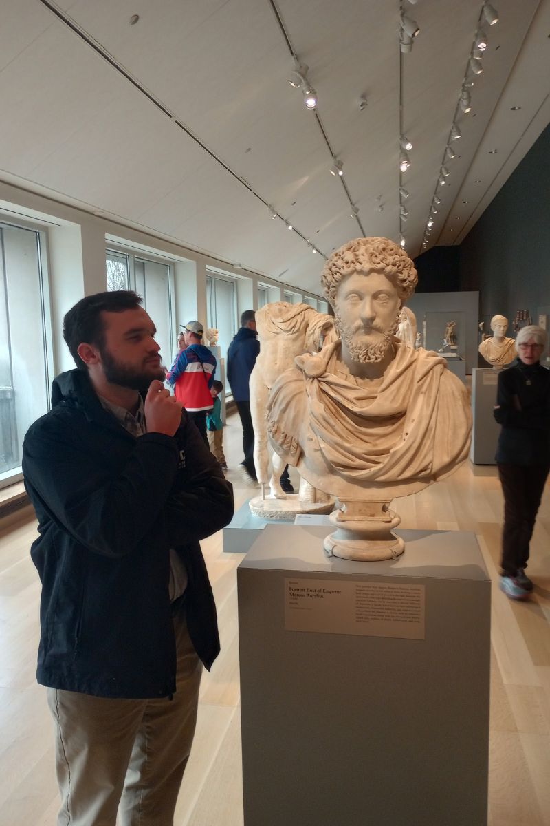 Ben Gervasi next to bust of Marcus Aurelius" src="https://cdn.web.uta.edu/-/media/project/website/news/releases/2025/05/ben-gervasi-4.ashx?la=en" _languageinserted="true