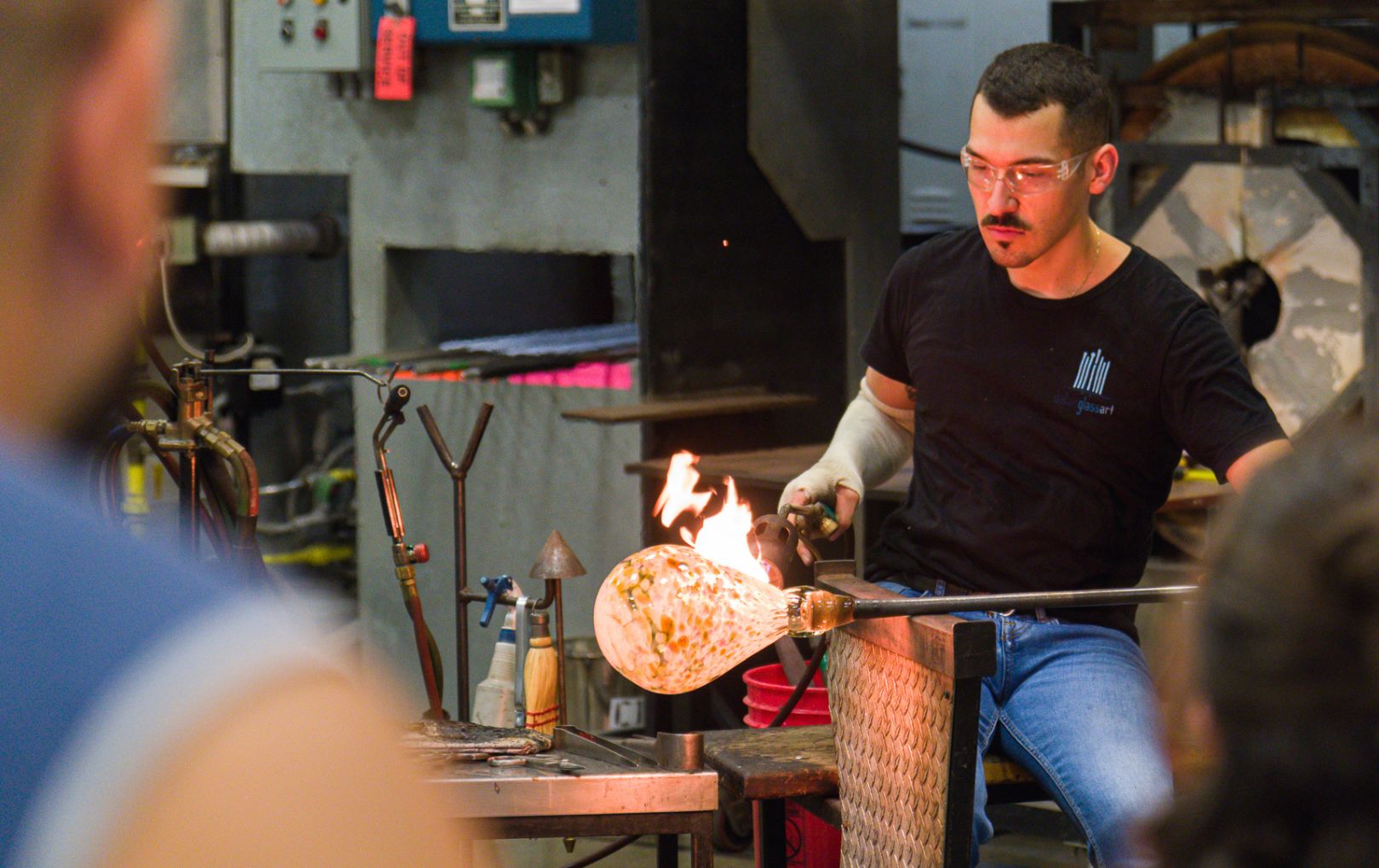 UTA student blowing glass